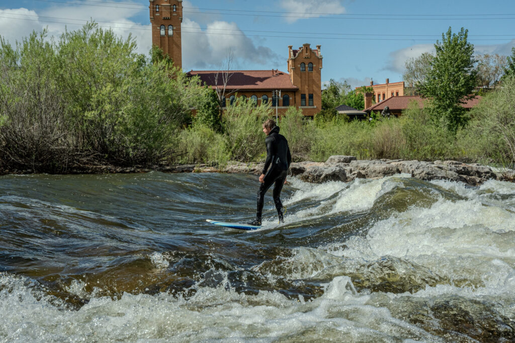 Surfer riding a river rapid